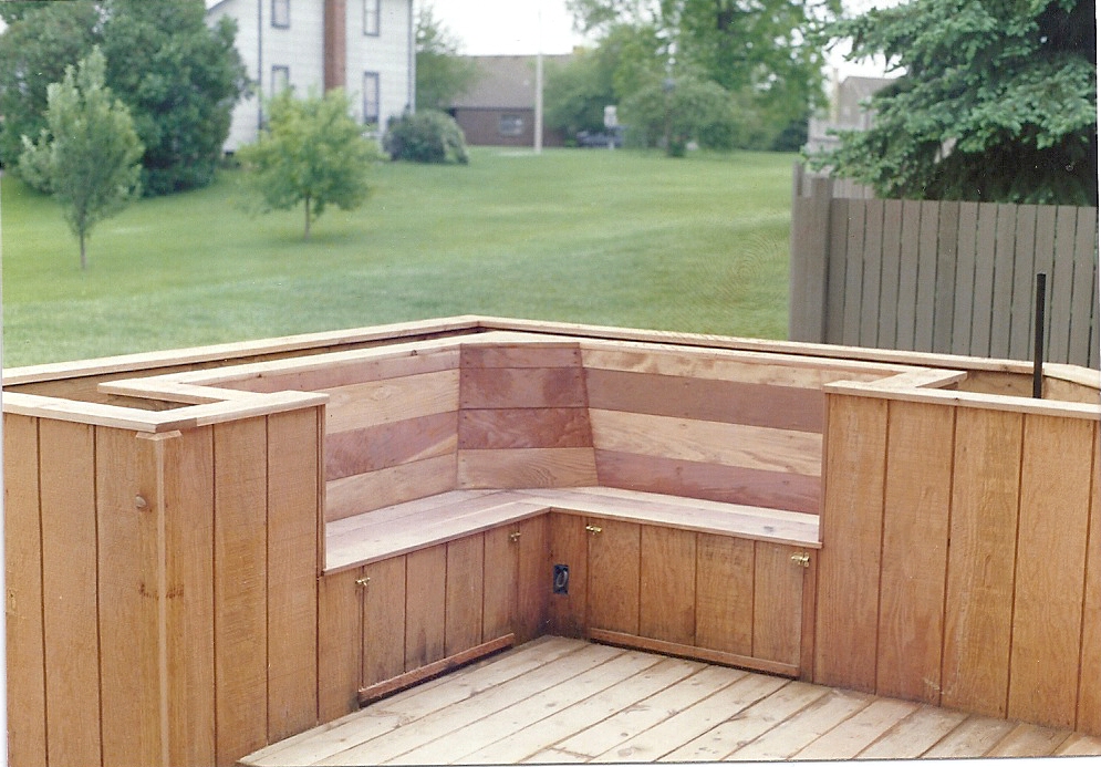  bench is surrounded with planters to help decorate the new deck area