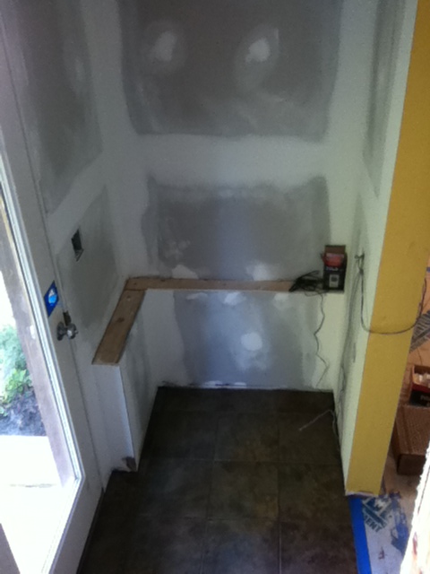 Drywall sanded, ceramic tile installed. before construction of locker cabinets Drywall sanded, ceramic tile installed. before construction of locker cabinets