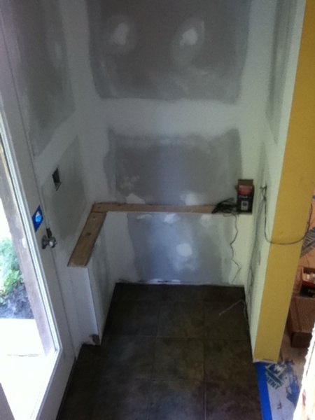 Drywall sanded, ceramic tile installed. before construction of locker cabinets Drywall sanded, ceramic tile installed. before construction of locker cabinets