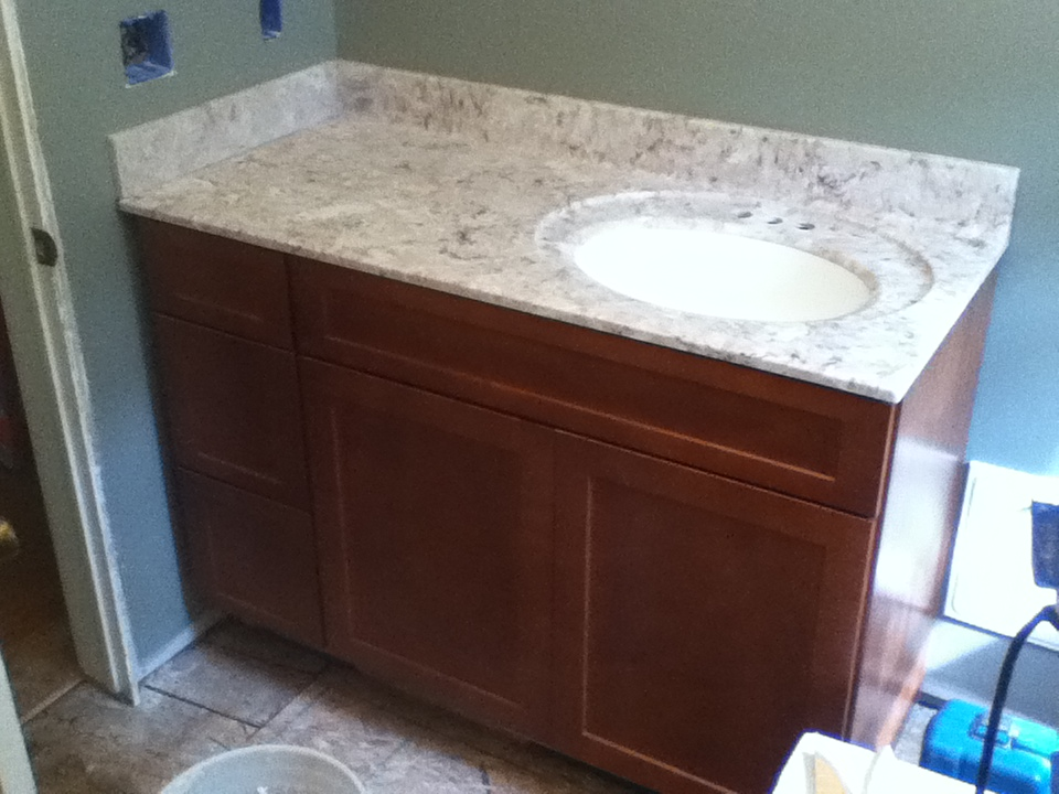 Bathroom vanity installation with marble counter top and back splash.