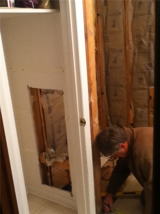 The new access panel was cut into the adjacent linen closet. Also seen are the insulated walls to help with noise reduction.