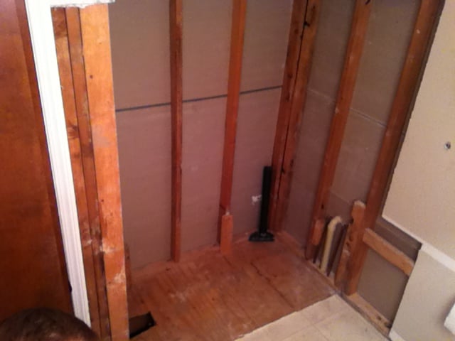 The walls around the shower were removed to bare studs. The walls were then insulated before the installation of the new tub.