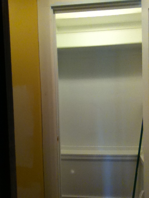Closet shelving installed, before coat rod installed. First coat of paint complete, trim installed.