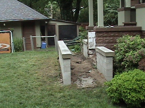 Masonry walls and concrete cap completed before paint applied.