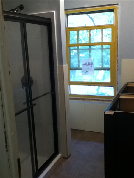 First coat of paint, bead board, vanity, ceramic tile, and shower stall in bathroom remodel.